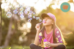 Little girl blowing soap bubbles